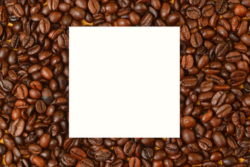 Texture of roasted coffee beans in flat lay angle with a blank  white space in middle..