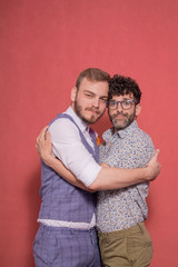 two men, gay couple portrait in studio, looking to camera.
