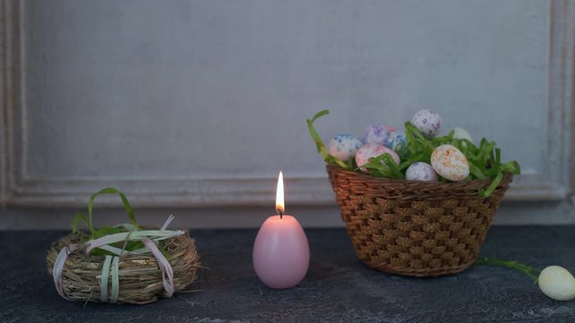 Painted ester eggs in a basket. White vintage wall in background. Copy space.