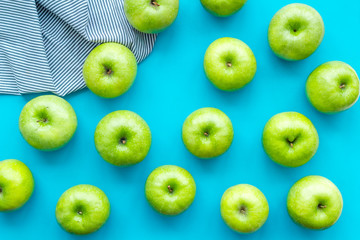food pattern with green apples on blue background top view