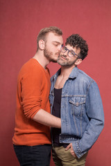 two young man, cuddling in front of camera.