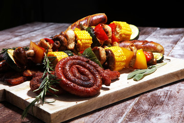 Assorted delicious grilled meat and skewer with vegetable on rustic table
