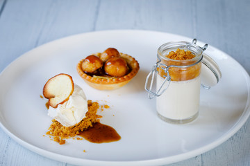 Trio of desserts, panna cotta, ice cream and apple tart
