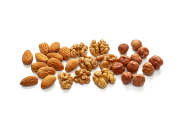 Three piles of almonds, walnuts and hazelnuts