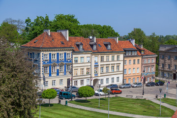 Fototapeta na wymiar Early color houses surrounded by green trees. Warsaw