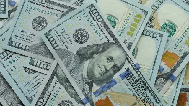 US 100-dollar bills being laid out on top of each other