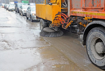 Sweeping harvester in traffic jam during rain