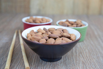 Almond nut on wood background.