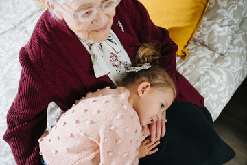 Happy moments. Little girl with her great grandma spending quality time together