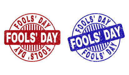 Grunge FOOLS' DAY round stamp seals isolated on a white background. Round seals with grunge texture in red and blue colors. Vector rubber watermark of FOOLS' DAY text inside circle form with stripes.