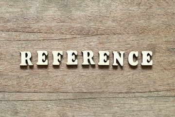 Letter block in word reference on wood background