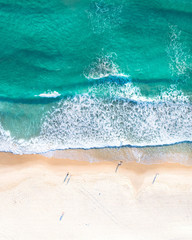 Ocean aerial landscape of surfer waiting for waves at sunrise with a beautiful light.