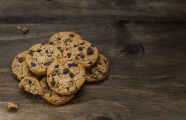 Classic chocolate chip cookies against wooden background. Concept of dessert, baking, and sweet food