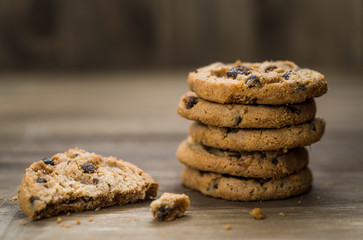 Classic chocolate chip cookies against wooden background. Concept of dessert, baking, and sweet food