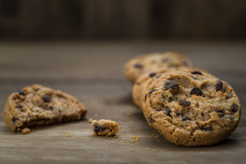 Classic chocolate chip cookies against wooden background. Concept of dessert, baking, and sweet food