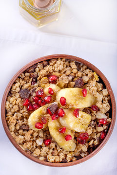 healthy breakfast granola with dry fruit,ripe banana and jair with honey. Copy space flatlay