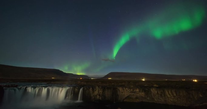 Timelapse of amazing northern lights over waterfall in Iceland