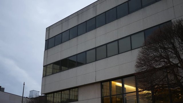 Establishing shot of generic corporate building in metropolitan area in evening