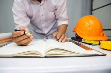 Engineer and Architect planing and discuss at Construction Site with blueprint.concept