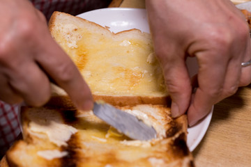 spread butter on bread at breakfast in the morning