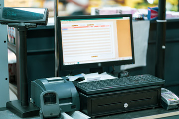 Cash-desk with cashier and terminal in supermarket