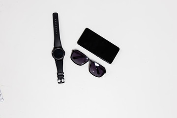 Top view sunglass and smart phone on flat lay