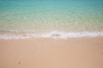 Fototapeta na wymiar Blue ocean soft sea wave on clear sandy beach