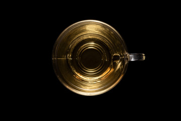 Top view of a glass cup of mint tea isolated on black background