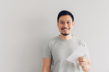 Man is happy with the white mail message or the bill.