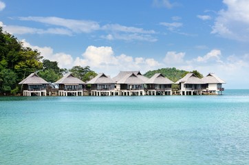 Tropical resort with bungalows on the water at the coastline of the Koh Chang island, Thailand.