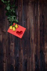 Valentine love card fresh rose and heart on wooden