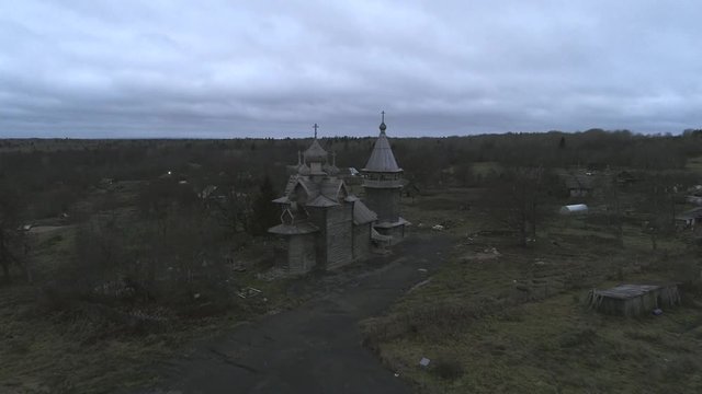 View of the old Church of St. Dmitry, November evening (aerial video). Sheleiki village, Leningrad region. Russia 