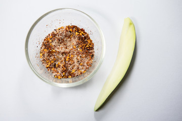 Thailand snack traditional ,Raw mango with salt and chile pepper sauce on white plate.