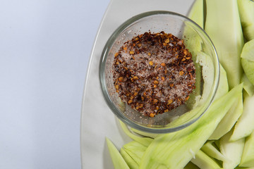Thailand snack traditional ,Raw mango with salt and chile pepper sauce on white plate.