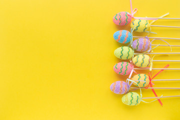 Colorful decorative Eggs on yellow background .Christian religious holiday. Happy Easter. Free spase. Top view