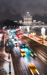 Beautiful background with the capital of Russia-Moscow. Evening Moscow on Christmas with the main attractions of the city and passing cars