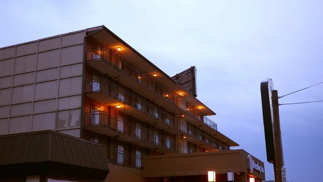 Establishing evening shot of cheap motel apartment complex