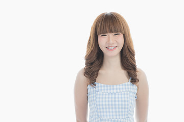 Front view close-up portrait of young beautiful Asian woman with curly long dark brown hair in...