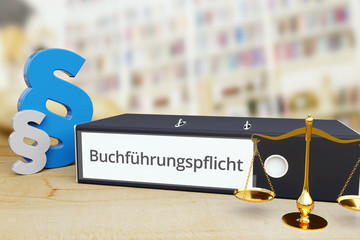 Buchführungspflicht – Gesetz/Recht. Ordner auf Schreibtisch mit Beschriftung neben Paragraf und Waage. Anwalt