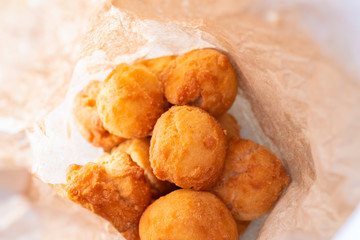 Nigerian Deep Fried buns in a paper bag