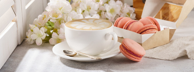 Coffee and french macarons for dessert. Sunny morning breakfast.