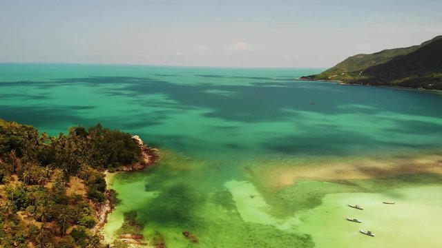 Aerial drone view island Koh Phangan Thailand. Exotic coast panoramic landscape, Chaloklum Malibu fisherman beach, summer day. Sandy path, corals. Vivid seascape, mountain coconut palms from above