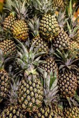 Ripe pineapples. Outdoor food market. Juicy tropical fruits. Healthy organic food. Bali island.