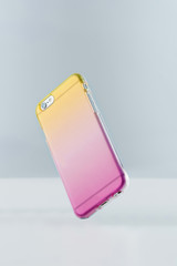 Cell phone and jelly color gradient phone case.