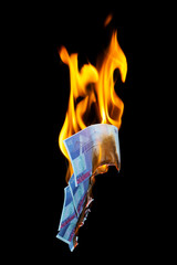 five hundred euro fakes are burning on a black background