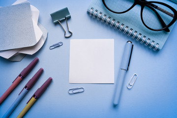 Workspace top view, copy space.Desk office with pencil, notebook,  and other office supplies. Flat lay, top view office table desk.Minmal workspace. Overhead of office table.Business desk on blue.