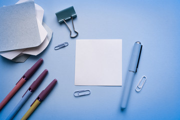 Workspace top view, copy space.Desk office with pencil, notebook,  and other office supplies. Flat lay, top view office table desk.Minmal workspace. Overhead of office table.Business desk on blue.