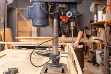 Industrial Iron drill ready for work in workshop interior. Close up on the drilling machine