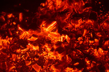 Fototapeta na wymiar Bright sparkling coals with fire as background