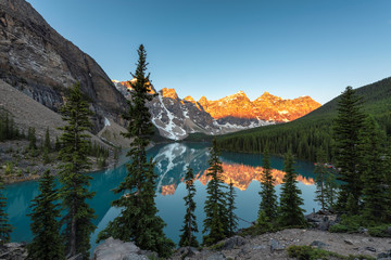 Spectacular view of sunrise at the Moraine lake with snow-covered rocky mountains in Banff National...